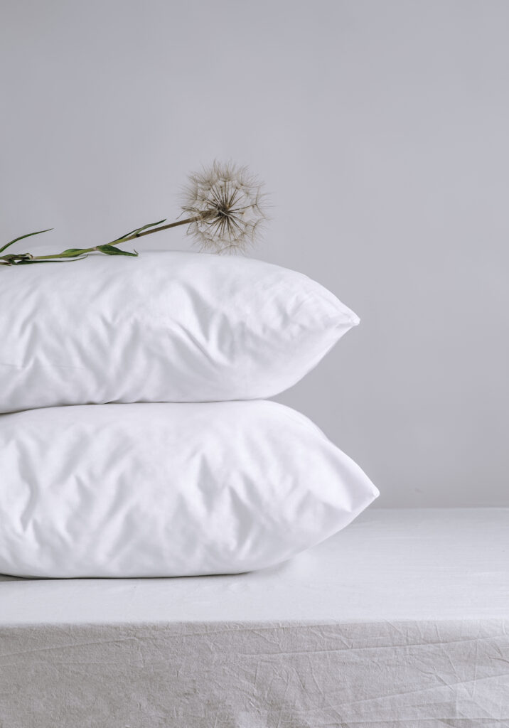 Two soft pillows on a bed in morning light