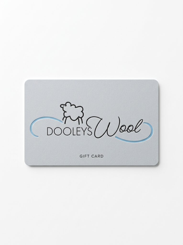 A luxurious light grey wool bedding gift card with the Dooley's Wool logo on it on a white background